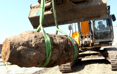 BERLIN, GERMANY - APRIL 20:  A digger carries an unexploded 500-kilogram (1,100-pound) bomb from World War II after its deactivation on April 20, 2018 in Berlin, Germany. The bomb, discovered during construction work near the city's central train station, brought disruption to Berlin as a bomb disposal unit defused the explosive, blocking off an 800-meter (half-mile) radius around the site as a precaution to local businesses and residents in the process. Hundreds of WWII bombs which failed to detonate during the War due to technical issues are found every year in the country. Between 1940 and 1945, American and British forces dropped nearly three million tons of explosives on Europe, half of which targeted Germany. A quarter of a million of these did not explode.  (Photo by Adam Berry/Getty Images)