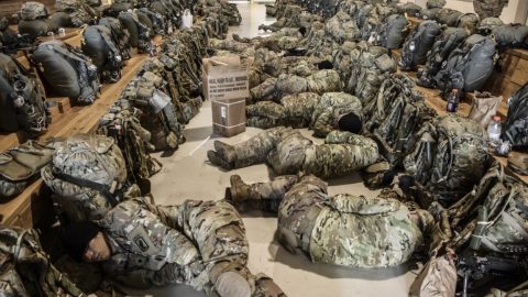 Soldiers with the 173rd Airborne sleep ahead of a jump. (photo by Lt. Col. John Hall/U.S. Army)
