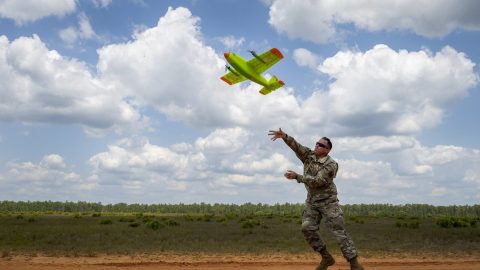 Blue Horizons fellow Col. Dustin Thomas launches the drone built in less than a day. (photo by Samuel King Jr./U.S. Air Force)