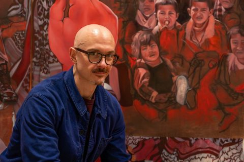 Mitchel Coffman in front of his triptych painting