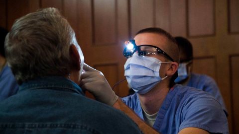 Dentist evaluating a service member.